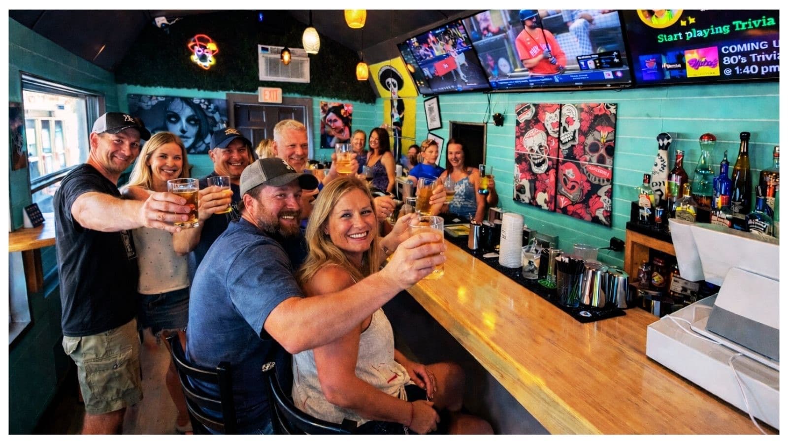 Guests raising drinks at the Salty Hobo bar